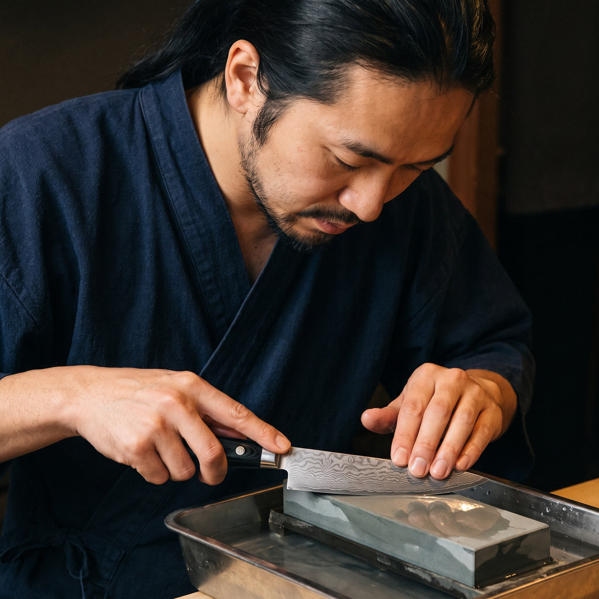 Hatori Kokuyō 黒曜 Series – Damascus Steak Knives, Set of 4, on the whetstone
