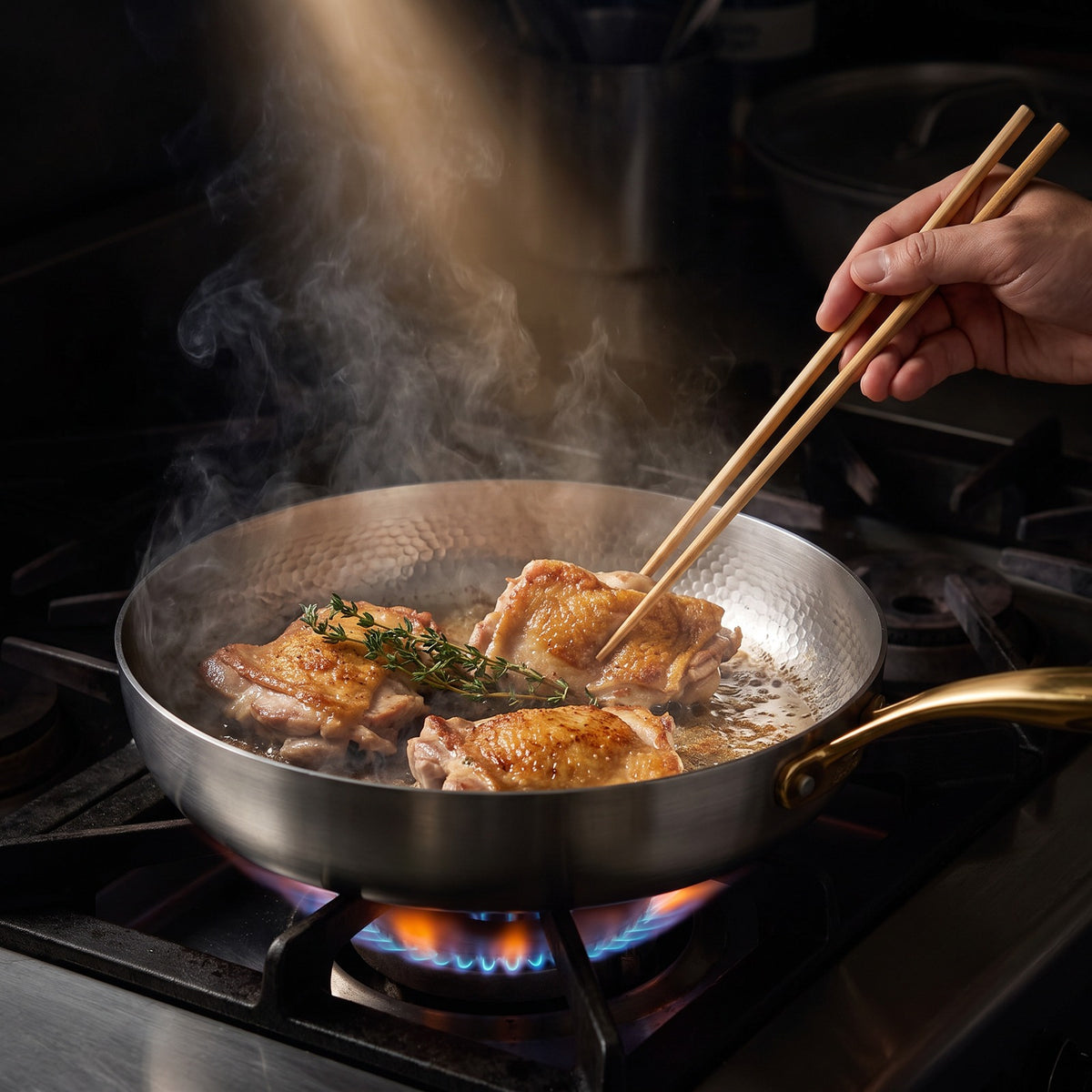 Hatori Kōmyō 光明 Kin 金 Edition – Hammered High-Wall Titanium Pan, in use on the stove