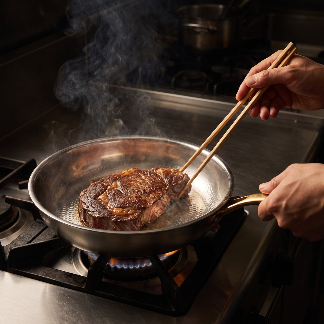 Hatori Kōmyō 光明 Kin 金 Edition – Hammered Titanium Pan, in use on the stove